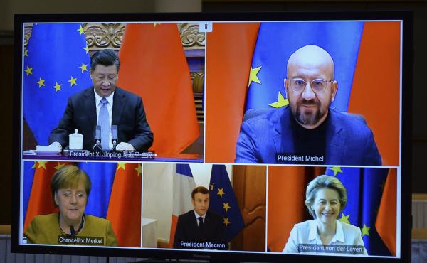 A screen displays Chinese President Xi Jinping (top left), European Council President Charles Michel (top right), European Commission President Ursula von der Leyen (bottom right), French President Emmanuel Macron and German Chancellor Angela Merkel durin A screen displays Chinese President Xi Jinping (top left), European Council President Charles Michel (top right), European Commission President Ursula von der Leyen (bottom right), French President Emmanuel Macron and German Chancellor Angela Merkel durin