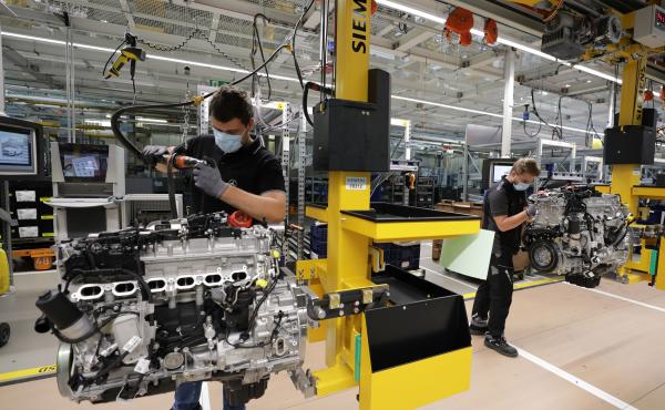 Employees assemble motors at a Mercedes-Benz factory in Stuttgart, Germany, on Wednesday. The German government pays much of laid-off workers' salaries for up to 12 months during economic crises. Employees assemble motors at a Mercedes-Benz factory in Stuttgart, Germany, on Wednesday. The German government pays much of laid-off workers' salaries for up to 12 months during economic crises.