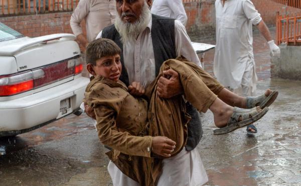 A volunteer carries an injured youth to a hospital after an explosion that killed at least 62 people in the Haska Mina district of Nangarhar province Friday. A volunteer carries an injured youth to a hospital after an explosion that killed at least 62 people in the Haska Mina district of Nangarhar province Friday.