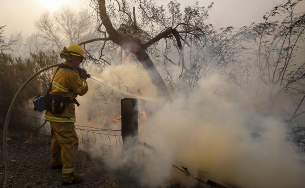 A firefighter battles a wildfire near a ranch in Simi Valley, Calif., on Wednesday. The large new wildfire erupted in wind-whipped Southern California, forcing the evacuation of the Ronald Reagan Presidential Library and nearby homes. A firefighter battles a wildfire near a ranch in Simi Valley, Calif., on Wednesday. The large new wildfire erupted in wind-whipped Southern California, forcing the evacuation of the Ronald Reagan Presidential Library and nearby homes.