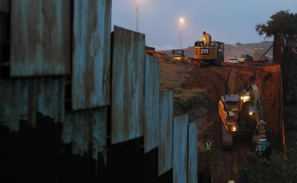 Contractors work to reinforce a section of the U.S. border wall in San Diego where scores of Central American migrants have crossed illegally in recent weeks, shot through the fence from Tijuana, Mexico. Contractors work to reinforce a section of the U.S. border wall in San Diego where scores of Central American migrants have crossed illegally in recent weeks, shot through the fence from Tijuana, Mexico.