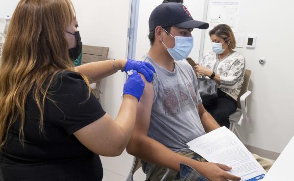 This 16-year-old got his Pfizer-BioNTech COVID-19 shot late last month at the UCI Health Family Health Center in Anaheim, Calif. Students as young as 12 are now eligible to get the vaccine, too, the FDA says. This 16-year-old got his Pfizer-BioNTech COVID-19 shot late last month at the UCI Health Family Health Center in Anaheim, Calif. Students as young as 12 are now eligible to get the vaccine, too, the FDA says.