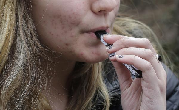 An unidentified 15-year-old student at a high school in Cambridge, Mass., vaped near campus in April. An unidentified 15-year-old student at a high school in Cambridge, Mass., vaped near campus in April.
