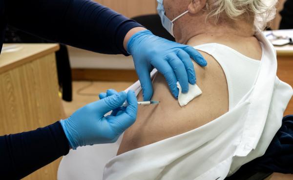 A healthcare worker administers a dose of the coronavirus vaccine to an elderly at a health center in the Cypriot coastal city of Limassol on February 8, 2021. A healthcare worker administers a dose of the coronavirus vaccine to an elderly at a health center in the Cypriot coastal city of Limassol on February 8, 2021.