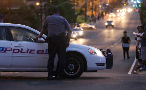 A Baton Rouge, La., police officer redirects traffic away from a protest march following the death of Alton Sterling last July. A Baton Rouge, La., police officer redirects traffic away from a protest march following the death of Alton Sterling last July.