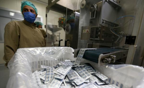 An employee of a Syrian pharmaceutical factory works on the production line of the hydroxychloroquine drug on April 28, in the government-controlled city of Homs. An employee of a Syrian pharmaceutical factory works on the production line of the hydroxychloroquine drug on April 28, in the government-controlled city of Homs.