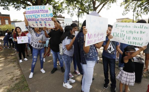Children of mainly Latino immigrant parents hold signs in support of them and other individuals swept up during an immigration raid at a food processing plant in Mississippi. Children of mainly Latino immigrant parents hold signs in support of them and other individuals swept up during an immigration raid at a food processing plant in Mississippi.