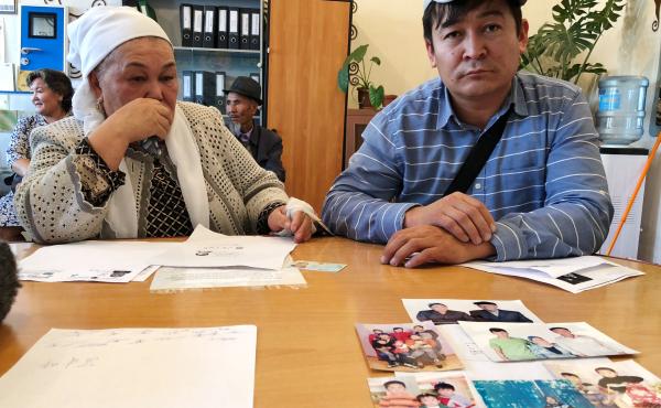 Kalida Akytkhan, pictured with her son Parkhat Rakhymbergen, has two sons and two daughter-in-laws who have been detained in re-education camps in Xinjiang. She brought photos of her family to the offices of rights organization Atazhurt in Almaty. Kalida Akytkhan, pictured with her son Parkhat Rakhymbergen, has two sons and two daughter-in-laws who have been detained in re-education camps in Xinjiang. She brought photos of her family to the offices of rights organization Atazhurt in Almaty.