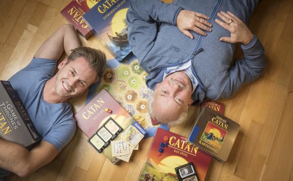 Klaus Teuber, creator of the popular board game Catan, with his son Benjamin Teuber, a managing director at Catan Inc. Celebrating the 25th anniversary of the game's launch, the elder Teuber has released an autobiography, My Way to Catan. Klaus Teuber, creator of the popular board game Catan, with his son Benjamin Teuber, a managing director at Catan Inc. Celebrating the 25th anniversary of the game's launch, the elder Teuber has released an autobiography, My Way to Catan.