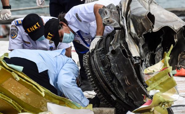 Indonesia's National Transportation Safety Committee (KNKT) officers check debris last month from the crash of a Sriwijaya Air Boeing 737-500 in Jakarta, Indonesia. Indonesia's National Transportation Safety Committee (KNKT) officers check debris last month from the crash of a Sriwijaya Air Boeing 737-500 in Jakarta, Indonesia.