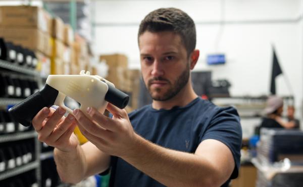 Cody Wilson, owner of Defense Distributed, holds a 3-D printed gun, called the "Liberator" in his factory in Austin, Texas, on Aug. 1. Cody Wilson, owner of Defense Distributed, holds a 3-D printed gun, called the "Liberator" in his factory in Austin, Texas, on Aug. 1.