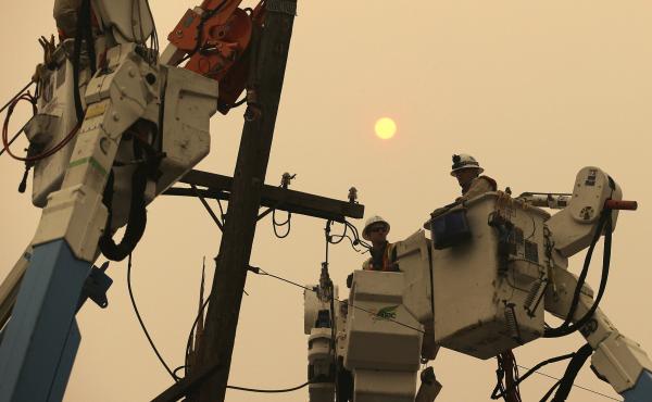 PG&E crews work to restore power lines in Paradise, Calif., after the Camp Fire destroyed much of the Northern California town. PG&E crews work to restore power lines in Paradise, Calif., after the Camp Fire destroyed much of the Northern California town.