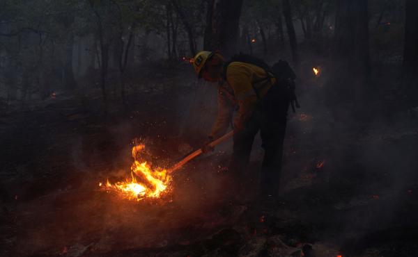 Firefighters battle flames as the Dixie Fire pushes through the Genesee Valley in California in August 2021. The fire was California's largest single wildfire in recorded history, burning nearly 1 million acres. Firefighters battle flames as the Dixie Fire pushes through the Genesee Valley in California in August 2021. The fire was California's largest single wildfire in recorded history, burning nearly 1 million acres.
