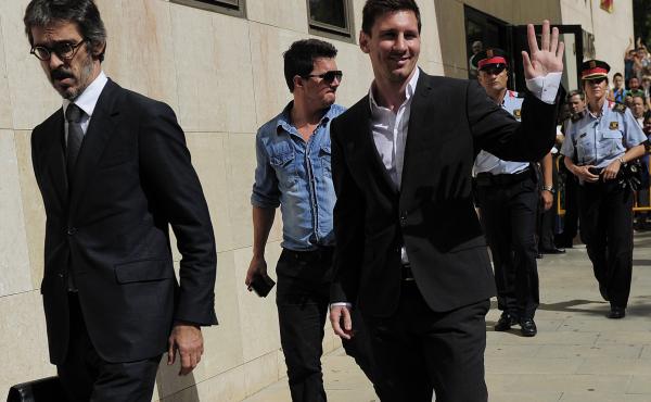 Barcelona football star Lionel Messi (right) leaves a courthouse in Gava, Spain, in September 2013, after a hearing on tax evasion charges. Messi and his father paid $6.5 million to try to settle the case, but his father may still go on trial. Barcelona football star Lionel Messi (right) leaves a courthouse in Gava, Spain, in September 2013, after a hearing on tax evasion charges. Messi and his father paid $6.5 million to try to settle the case, but his father may still go on trial.