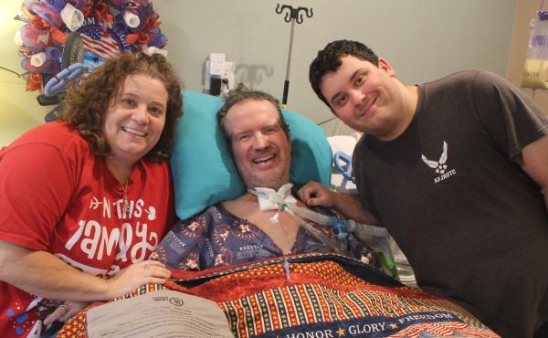 Lara and Trey Garey stand at the bedside of Tom Garey, an Air Force veteran with advanced ALS. Trey, 19, has spent much of his teenage years caring for his father at their Texas home. Lara and Trey Garey stand at the bedside of Tom Garey, an Air Force veteran with advanced ALS. Trey, 19, has spent much of his teenage years caring for his father at their Texas home.