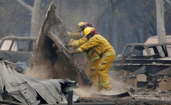 Cal Fire firefighters comb through a house destroyed by the Camp Fire in Paradise, Calif., on Tuesday. Cal Fire firefighters comb through a house destroyed by the Camp Fire in Paradise, Calif., on Tuesday.