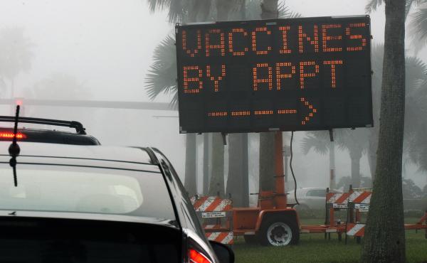 A sign directs drivers to a COVID-19 vaccination site at the Orange County Convention Center in Orlando, Fla. Health officials in Orange County said on Thursday that two women were caught dressing up as "grannies" in an effort to cut the vaccine line. A sign directs drivers to a COVID-19 vaccination site at the Orange County Convention Center in Orlando, Fla. Health officials in Orange County said on Thursday that two women were caught dressing up as "grannies" in an effort to cut the vaccine line.