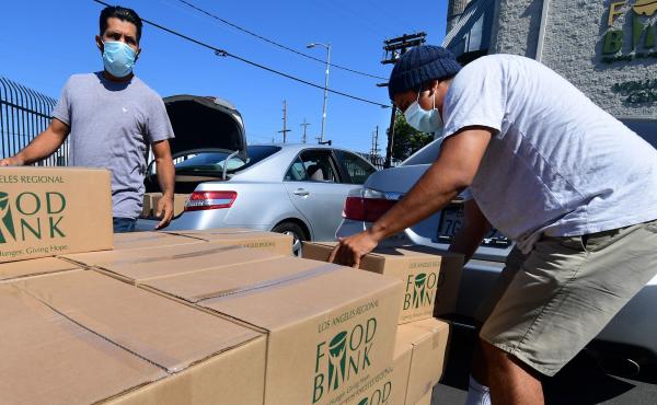 People load their vehicles with boxes of food at a Los Angeles Regional Food Bank earlier this month in Los Angeles. Food banks across the United States are seeing numbers and people they have never seen before amid unprecedented unemployment from the COV People load their vehicles with boxes of food at a Los Angeles Regional Food Bank earlier this month in Los Angeles. Food banks across the United States are seeing numbers and people they have never seen before amid unprecedented unemployment from the COV
