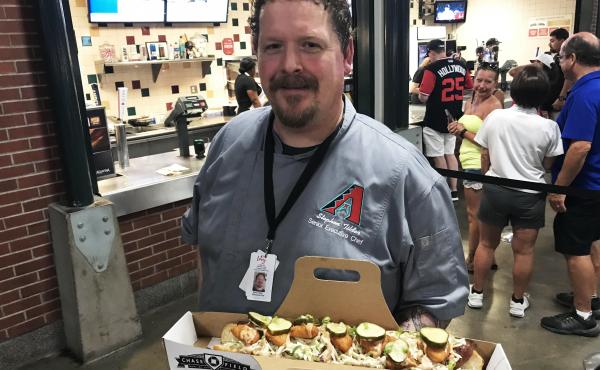 Stephen Tilder, the executive chef at Chase Field in Phoenix, holds the SI Cover Dog, a collaboration with a Sports Illustrated reporter. Stephen Tilder, the executive chef at Chase Field in Phoenix, holds the SI Cover Dog, a collaboration with a Sports Illustrated reporter.