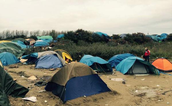 Tents dot the scrub brush in the dunes at "The Jungle," a camp in Calais, France, that houses about 6,000 migrants. Tents dot the scrub brush in the dunes at "The Jungle," a camp in Calais, France, that houses about 6,000 migrants.