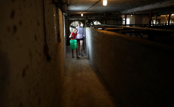 Eve Clark, 10, and Maggie Berry, 17, help with chores at Vision Aire Farms. They are seen in the barn, adjacent to the milking parlor. Eve Clark, 10, and Maggie Berry, 17, help with chores at Vision Aire Farms. They are seen in the barn, adjacent to the milking parlor.