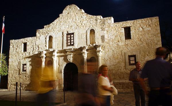 Visitors walk around the outside of the Alamo in San Antonio. Visitors walk around the outside of the Alamo in San Antonio.