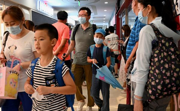Students and parents walk after a private after-school session in Beijing's Haidan district, where competition is cutthroat for a spot in top schools. Students and parents walk after a private after-school session in Beijing's Haidan district, where competition is cutthroat for a spot in top schools.