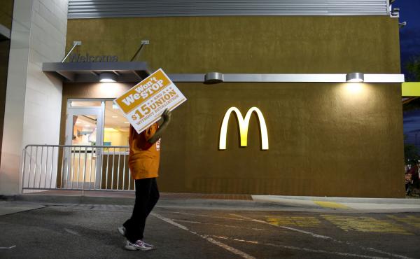 Protesters gather at a McDonald's to ask for higher wages on April 15, 2015 in Miami Gardens, Fla. Food labor advocate Saru Jayaraman writes in a new book that the company has taken the "low road" and lobbied extensively for lower wages and working condit Protesters gather at a McDonald's to ask for higher wages on April 15, 2015 in Miami Gardens, Fla. Food labor advocate Saru Jayaraman writes in a new book that the company has taken the "low road" and lobbied extensively for lower wages and working condit