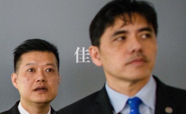 This 2017 photo shows the man on the right, identified by local Hong Kong media as former CIA agent Jerry Chun Shing Lee, standing in front of a member of security at the unveiling of Leonardo da Vinci's "Salvator Mundi" painting at the Christie's showroo This 2017 photo shows the man on the right, identified by local Hong Kong media as former CIA agent Jerry Chun Shing Lee, standing in front of a member of security at the unveiling of Leonardo da Vinci's "Salvator Mundi" painting at the Christie's showroo