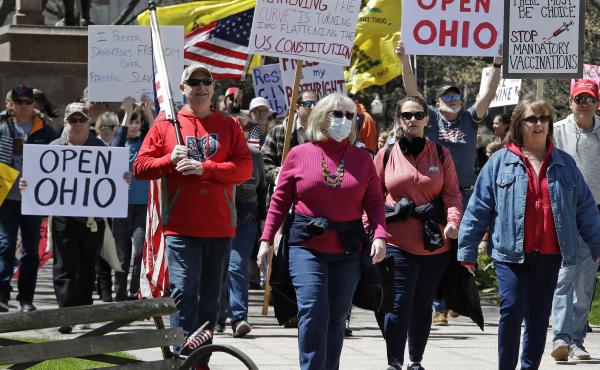 People gather outside the Ohio Statehouse in Columbus on Monday to protest the state's stay-at-home order, which is in effect until May 1. People gather outside the Ohio Statehouse in Columbus on Monday to protest the state's stay-at-home order, which is in effect until May 1.
