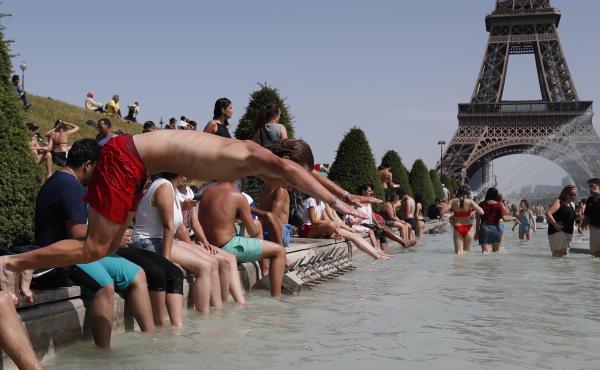 A boy jumps into the water of the Trocadero Fountain in Paris on Friday, to find relief from the heat wave. A boy jumps into the water of the Trocadero Fountain in Paris on Friday, to find relief from the heat wave.