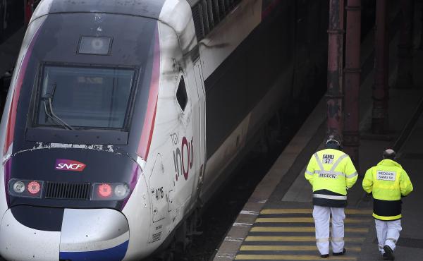 Emergency medical personnel walk by a high-speed TGV train in Strasbourg station on Wednesday, preparing to evacuate 20 COVID-19 patients to hospitals in western France. Emergency medical personnel walk by a high-speed TGV train in Strasbourg station on Wednesday, preparing to evacuate 20 COVID-19 patients to hospitals in western France.