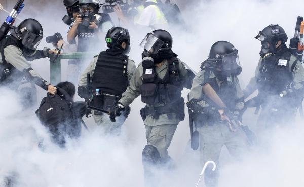 Police in riot gear move through a cloud of smoke as they detain a protester, in November. Freedom House cited the willingness of people in Hong Kong to protest as encouraging. Police in riot gear move through a cloud of smoke as they detain a protester, in November. Freedom House cited the willingness of people in Hong Kong to protest as encouraging.