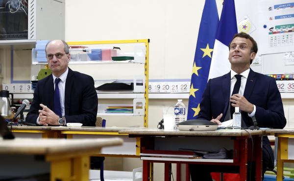 French Education Minister Jean-Michel Blanquer (left) and French President Emmanuel Macron participate in a video conference with mayors and directors of schools at the Pierre Ronsard elementary school in Poissy, west of Paris, on Tuesday. French Education Minister Jean-Michel Blanquer (left) and French President Emmanuel Macron participate in a video conference with mayors and directors of schools at the Pierre Ronsard elementary school in Poissy, west of Paris, on Tuesday.
