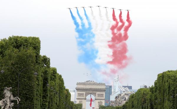 The French elite acrobatic flying team Patrouille de France performs a flying display of the French national flag over the Arc de Triomphe during the annual Bastille Day military ceremony in Paris on Tuesday. The French elite acrobatic flying team Patrouille de France performs a flying display of the French national flag over the Arc de Triomphe during the annual Bastille Day military ceremony in Paris on Tuesday.