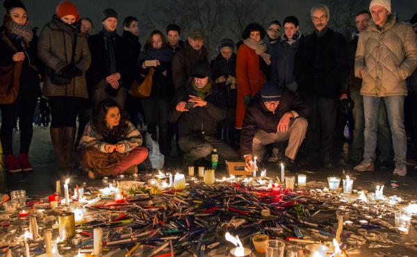 Pens are thrown on the ground during a vigil in Paris following a deadly attack at the offices of Charlie Hebdo, the weekly satirical magazine. Pens are thrown on the ground during a vigil in Paris following a deadly attack at the offices of Charlie Hebdo, the weekly satirical magazine.