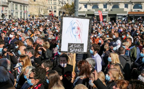 Demonstrators wearing face masks gather Sunday in Marseille, France, to pay tribute to teacher Samuel Paty, who was beheaded after he showed his class cartoons depicting the Prophet Muhammad. Demonstrators wearing face masks gather Sunday in Marseille, France, to pay tribute to teacher Samuel Paty, who was beheaded after he showed his class cartoons depicting the Prophet Muhammad.