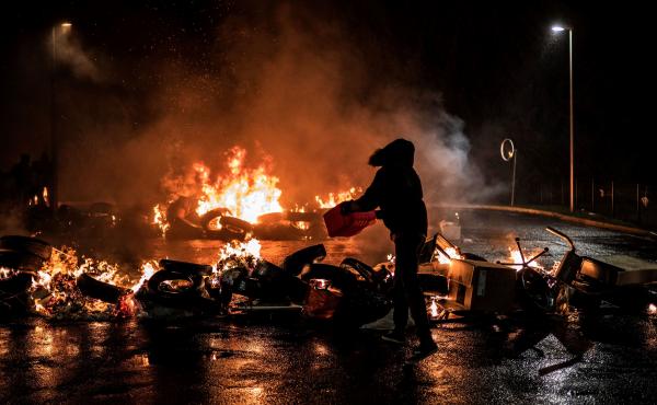 Striking prison guards light a fire as they demonstrate in front of Villefranche-sur-Saone prison on Monday as part of a nationwide movement to call for improved safety and wages. Striking prison guards light a fire as they demonstrate in front of Villefranche-sur-Saone prison on Monday as part of a nationwide movement to call for improved safety and wages.