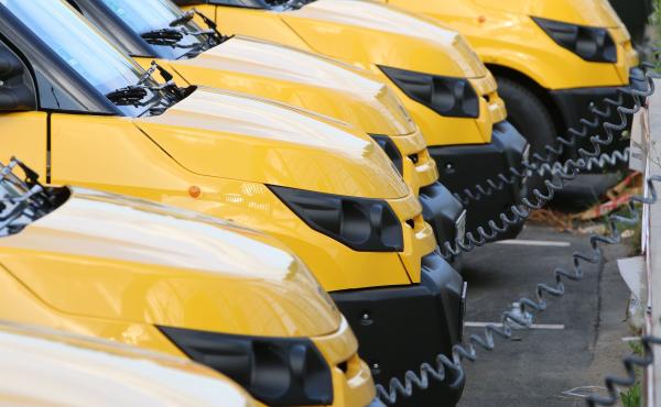 Electric vans charge at a warehouse of the German postal and logistics service Deutsche Post near Frankfurt in July 2018. Fleet vehicles are increasingly going electric in Europe and China, and some analysts say American fleets will be following suit. Electric vans charge at a warehouse of the German postal and logistics service Deutsche Post near Frankfurt in July 2018. Fleet vehicles are increasingly going electric in Europe and China, and some analysts say American fleets will be following suit.