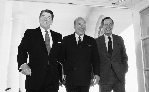 Secretary of State George Shultz, center, walks with President Reagan and Vice President George Bush on his arrival at the White House in January 1985 after two days of arms talks with the Soviet Union in Geneva. Shultz died Saturday at the age of 100. Secretary of State George Shultz, center, walks with President Reagan and Vice President George Bush on his arrival at the White House in January 1985 after two days of arms talks with the Soviet Union in Geneva. Shultz died Saturday at the age of 100.