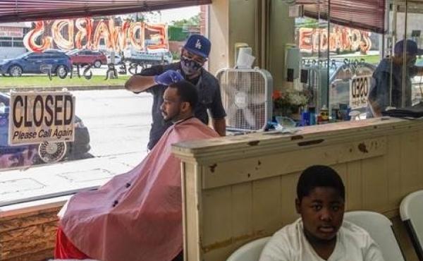 Marian Searcy cuts Shaquille Sanders' hair at Edward's Barber Shop in Macon, Ga., on Friday, the first day Gov. Brian Kemp said some businesses could reopen. Marian Searcy cuts Shaquille Sanders' hair at Edward's Barber Shop in Macon, Ga., on Friday, the first day Gov. Brian Kemp said some businesses could reopen.