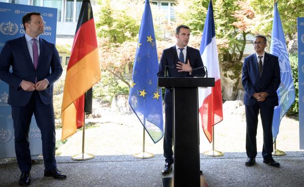 French Health and Solidarity Minister Olivier Veran (center), flanked by German Health Minister Jens Spahn (left) and World Health Organization Director-General Tedros Adhanom Ghebreyesus (right), speaks during a news conference at the WHO headquarters in French Health and Solidarity Minister Olivier Veran (center), flanked by German Health Minister Jens Spahn (left) and World Health Organization Director-General Tedros Adhanom Ghebreyesus (right), speaks during a news conference at the WHO headquarters in