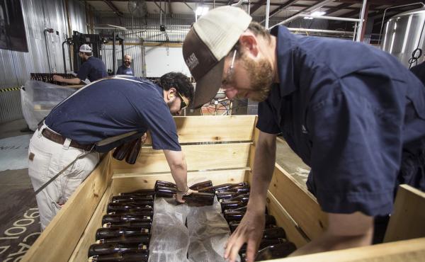 Allagash employees Salim Raal, left, and Brendan McKay stack bottles of Golden Brett, a limited release beer fermented with a house strain of Brettanomyces yeast. The Maine brewery recently installed solar panels as part of its sustainability initiatives. Allagash employees Salim Raal, left, and Brendan McKay stack bottles of Golden Brett, a limited release beer fermented with a house strain of Brettanomyces yeast. The Maine brewery recently installed solar panels as part of its sustainability initiatives.