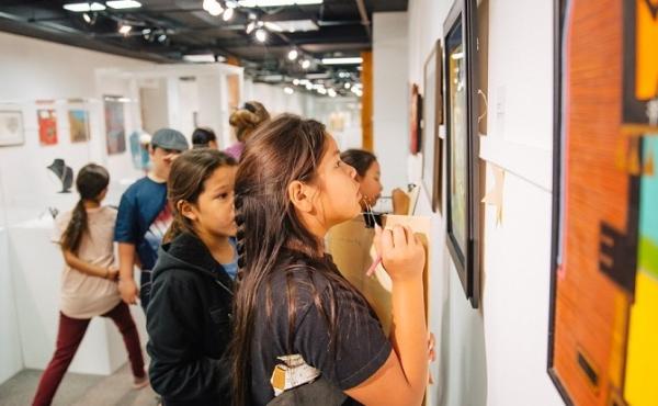 Students examine artworks on display at the Heritage Center at Red Cloud. Students examine artworks on display at the Heritage Center at Red Cloud.