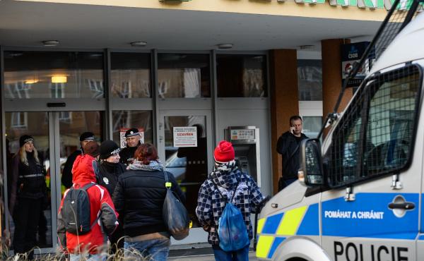 Police officers guard the doors of a teaching hospital in Ostrava, Czech Republic, after a gunman carried out a mass shooting in its waiting room Tuesday morning. Police officers guard the doors of a teaching hospital in Ostrava, Czech Republic, after a gunman carried out a mass shooting in its waiting room Tuesday morning.
