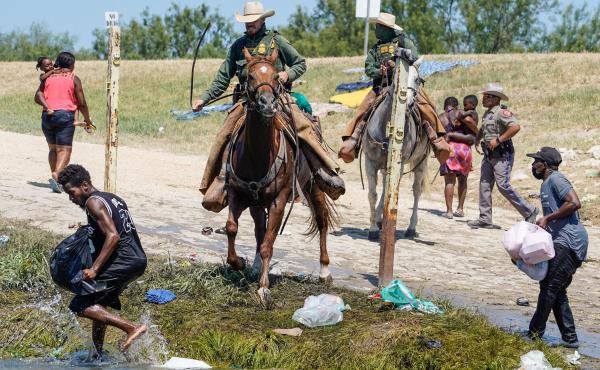 United States Border Patrol agents on horseback try to stop Haitian migrants from entering an encampment on the banks of the Río Grande near the Acuña Del Río International Bridge in Del Río, Texas on Sept. 19. United States Border Patrol agents on horseback try to stop Haitian migrants from entering an encampment on the banks of the Río Grande near the Acuña Del Río International Bridge in Del Río, Texas on Sept. 19.