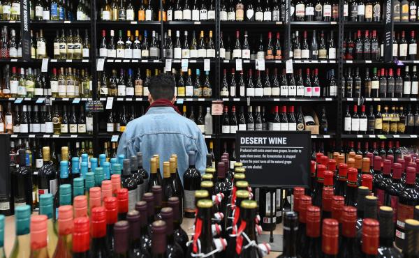 A patron stands in front of a shelf full of wine bottles at a liquor story in the Brooklyn borough of New York City on March 20. A patron stands in front of a shelf full of wine bottles at a liquor story in the Brooklyn borough of New York City on March 20.