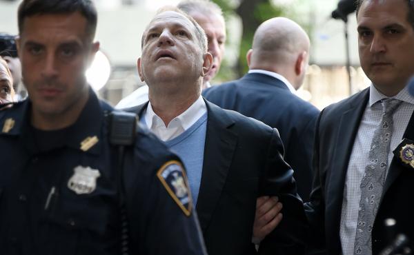 Law enforcement officers usher a handcuffed Harvey Weinstein into the courthouse for his arraignment in Manhattan on Friday. Law enforcement officers usher a handcuffed Harvey Weinstein into the courthouse for his arraignment in Manhattan on Friday.