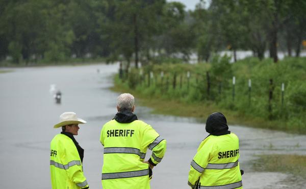 Members of the Harris County Sheriff's Office stand at the launching point for civilian rescue boats in Cypress, Texas, on Tuesday. Local authorities have confirmed multiple deaths caused by Hurricane Harvey and subsequent flooding. Members of the Harris County Sheriff's Office stand at the launching point for civilian rescue boats in Cypress, Texas, on Tuesday. Local authorities have confirmed multiple deaths caused by Hurricane Harvey and subsequent flooding.