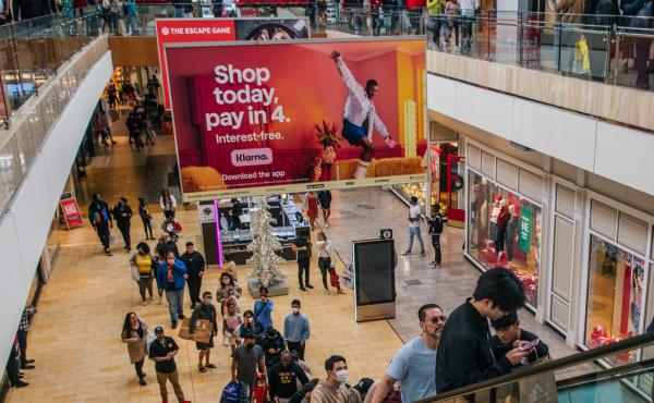 An ad for Klarna's "buy now, pay later" offer overlooks mall goers in Houston. An ad for Klarna's "buy now, pay later" offer overlooks mall goers in Houston.